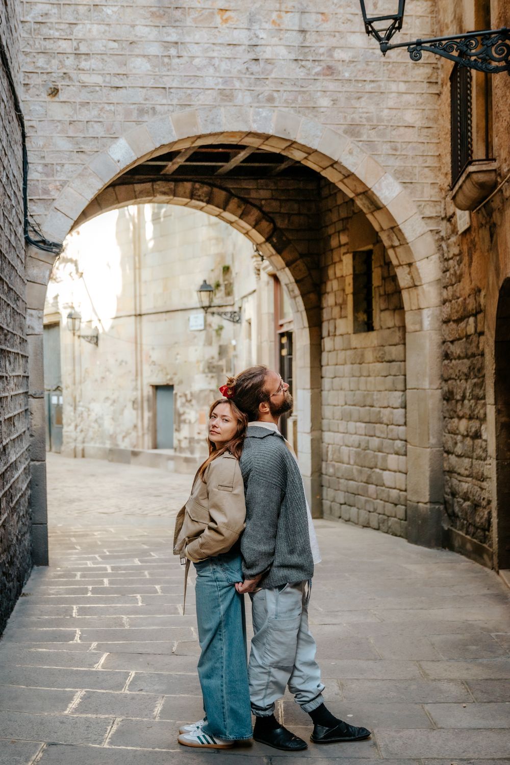 Framed shot through an archway of the couple holding each other.
