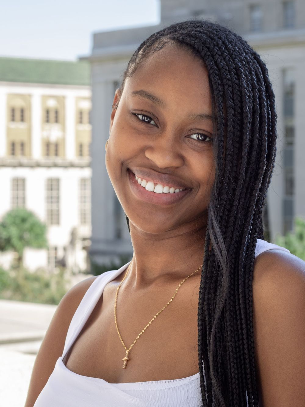 Outdoor graduation portraits taken in front of a stately academic building.