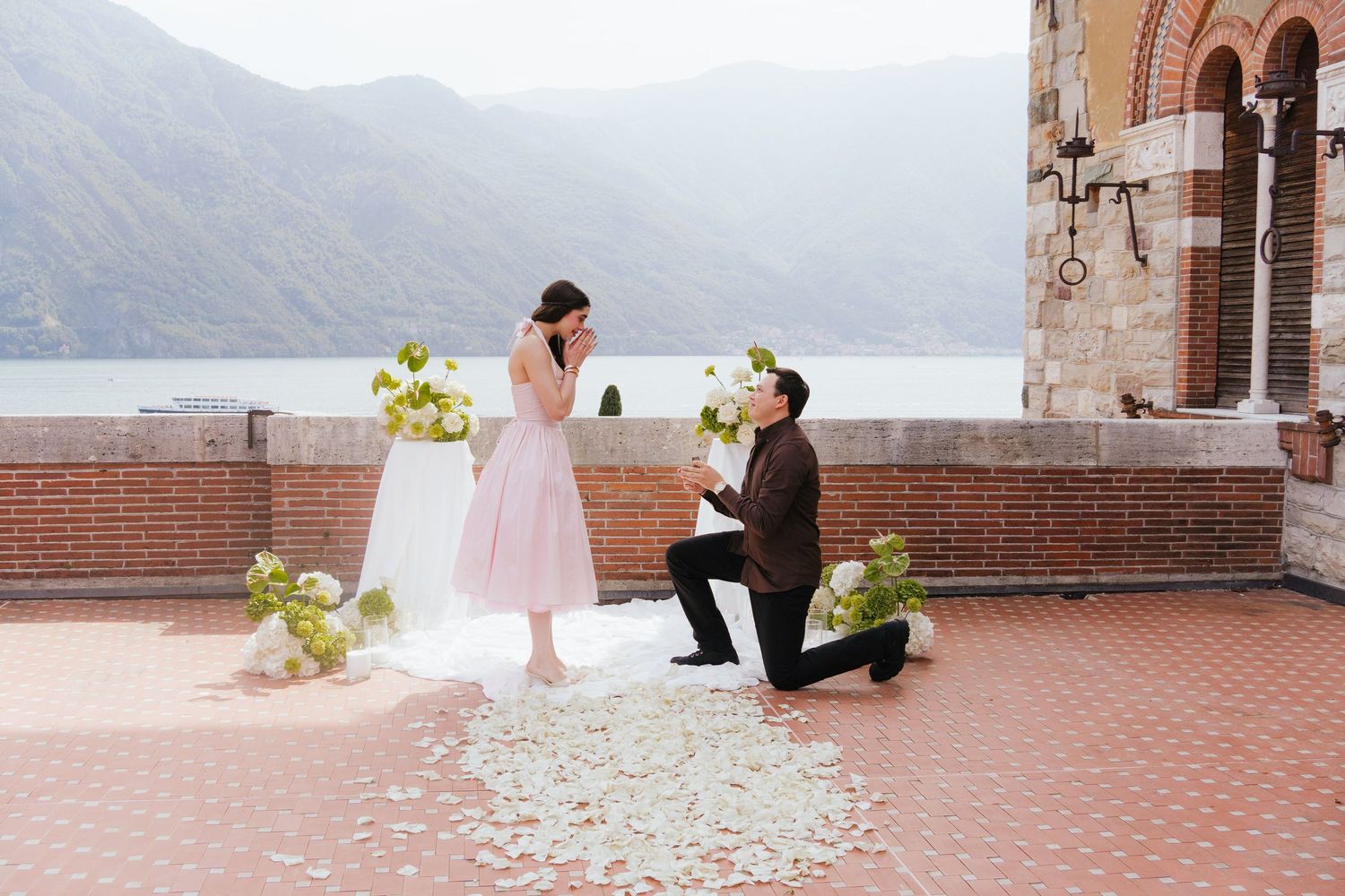 Garden marriage proposal moment captured in romantic outdoor setting.