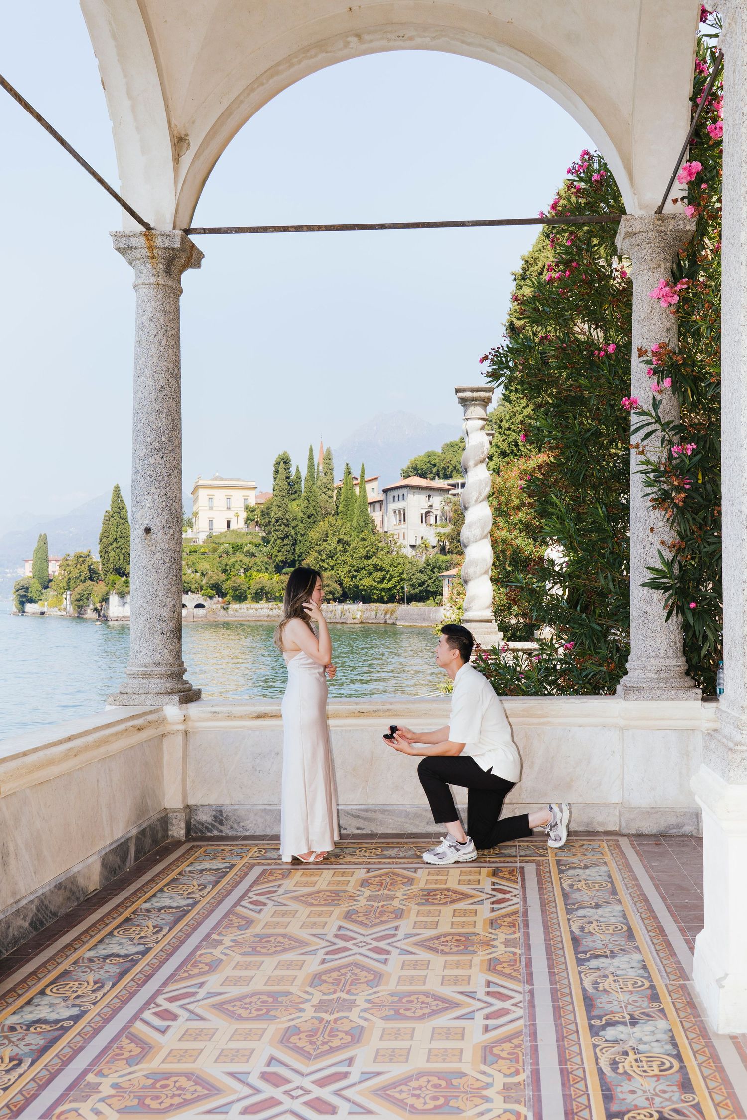 Garden marriage proposal moment captured in romantic outdoor setting.