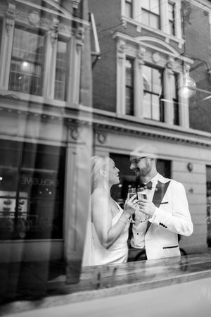 Artistic black and white moment of bride and groom toasting at their Table 47 reception in Nottingham’s Lace Market.