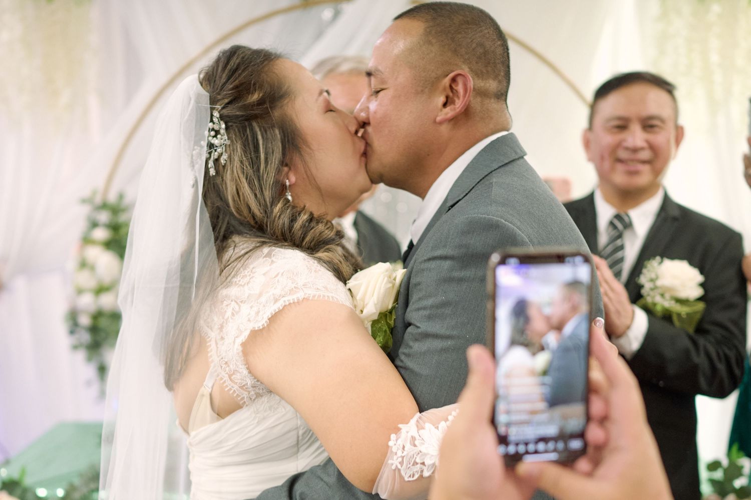Bride and Groom's first kiss being captured by an iPhone at Fairfield Inn & Suites Lodi, California.