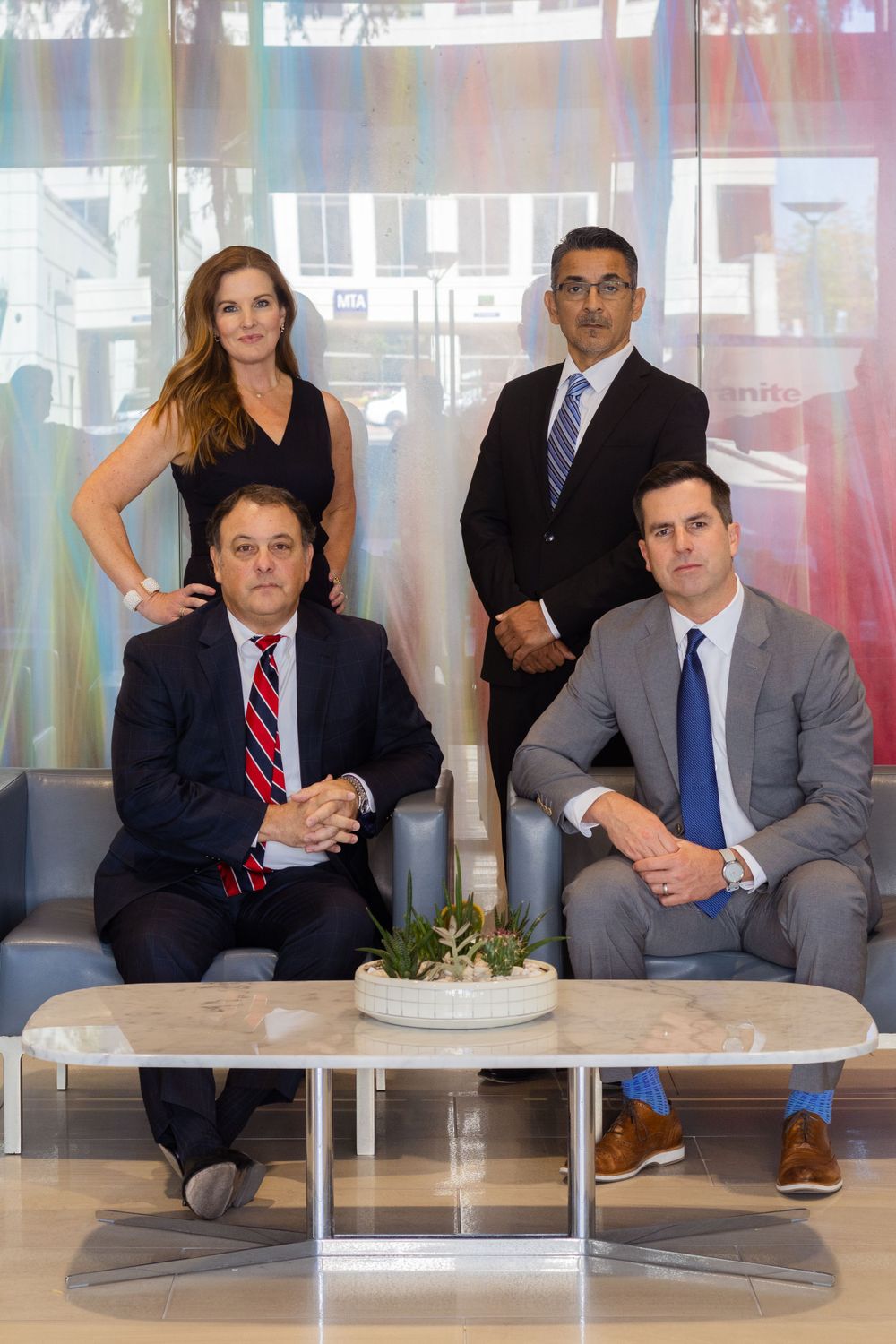 Business professionals seated at conference table in modern office setting.