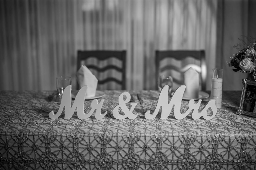 Black and white image of 'Mr & Mrs' table decor at an elegant wedding reception.