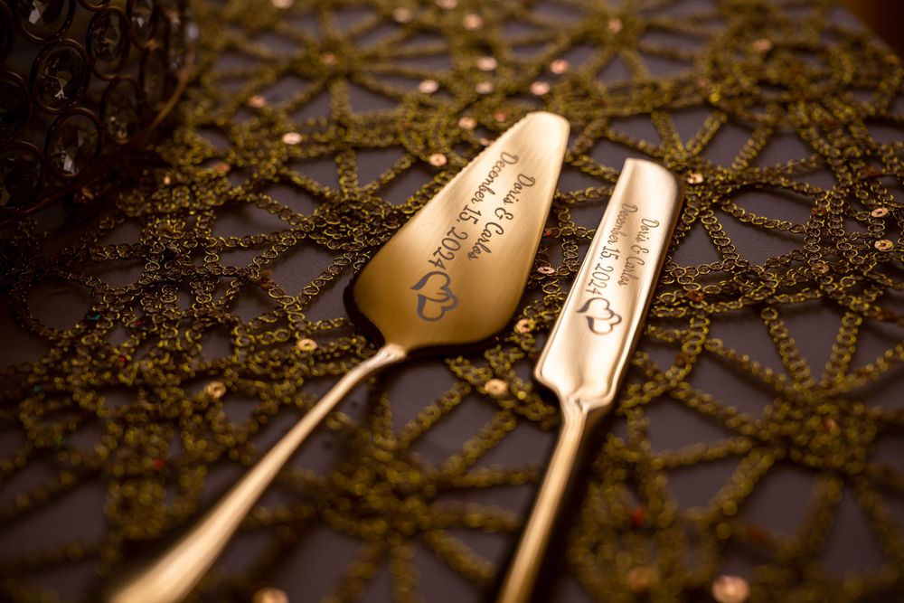 Gold-plated cake serving set displayed on decorative lace tablecloth.