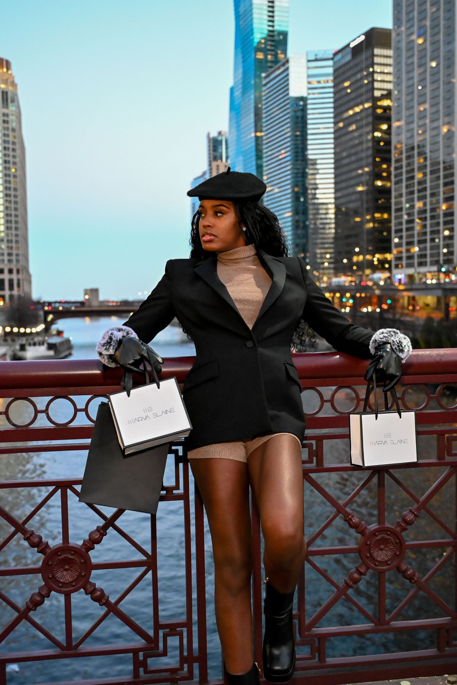 Stylish fashion portrait on Chicago's riverwalk with city skyscrapers in the background.