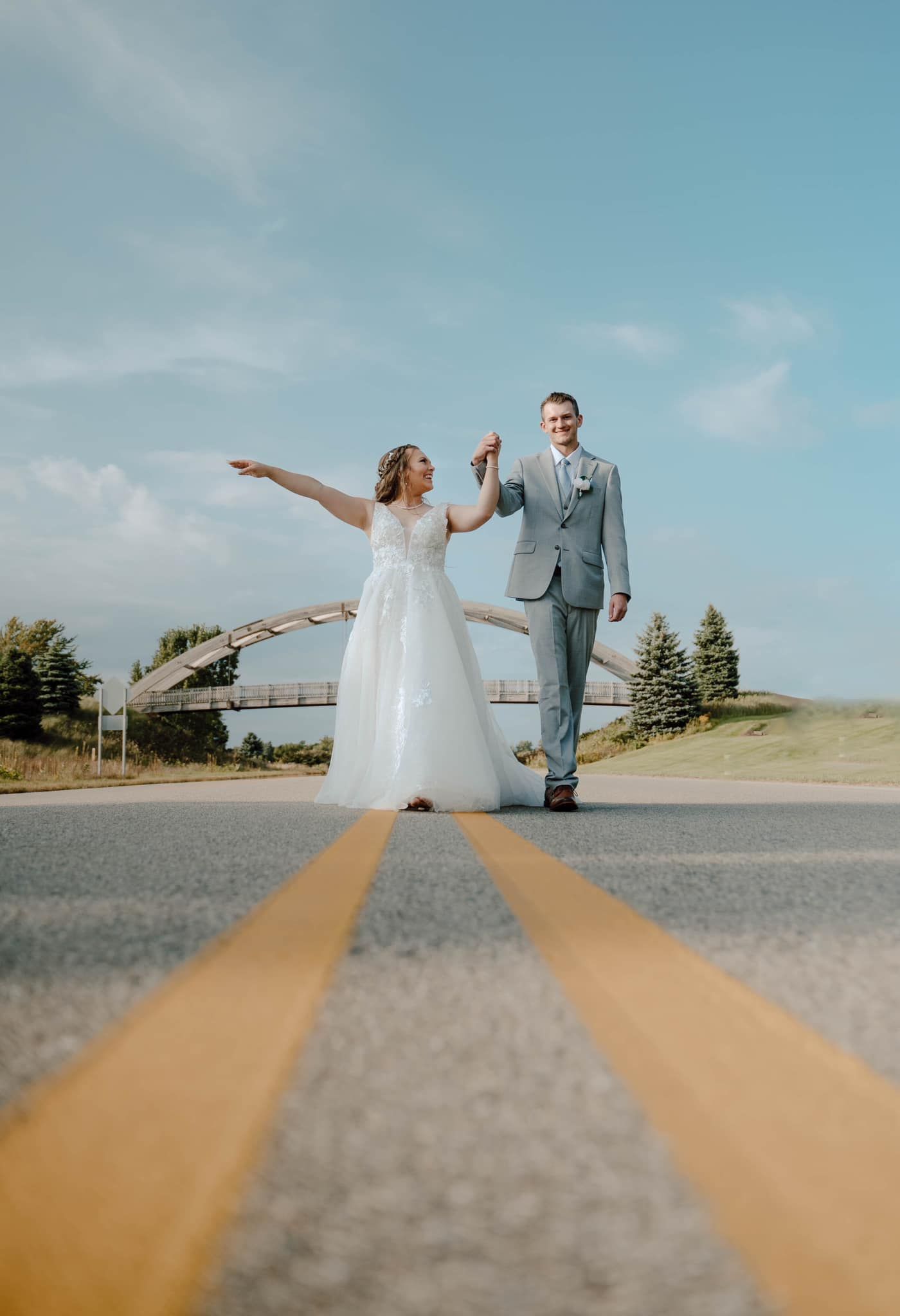 bride and groom in road