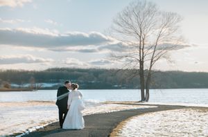 couple in winter walking towards lake