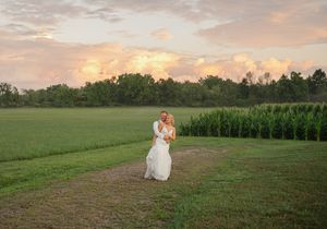 pretty sunset with bride and groom holding eachother