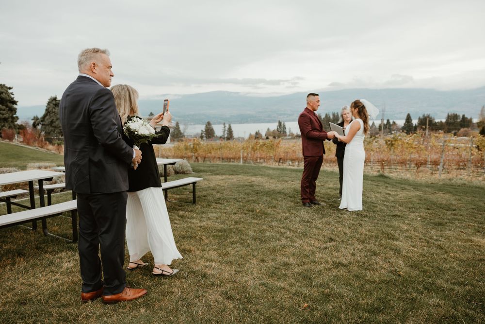 photo of couple watching friends get married at beautiful west kelowna winery