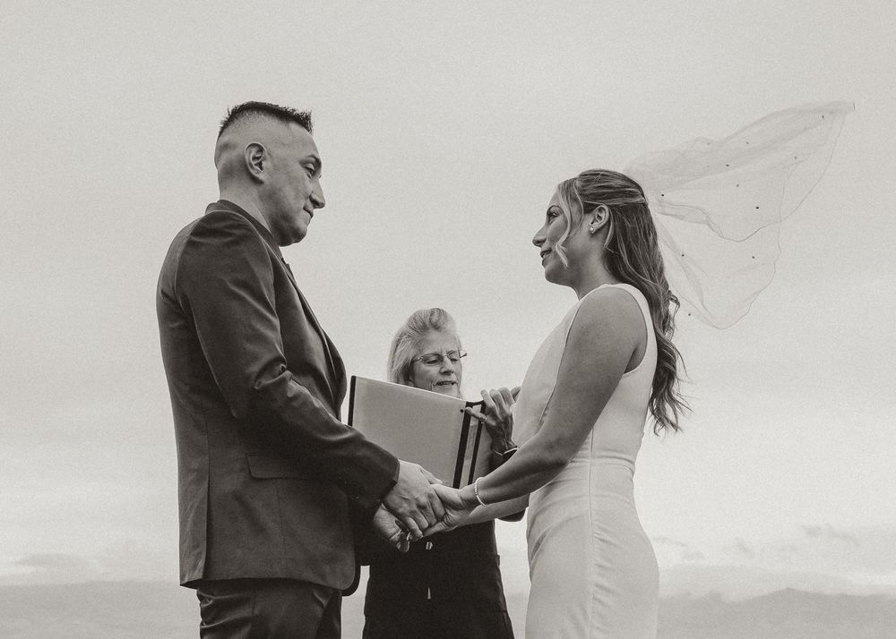 intimate black and white image of bride and groom embracing during ceremony in kelowna bc