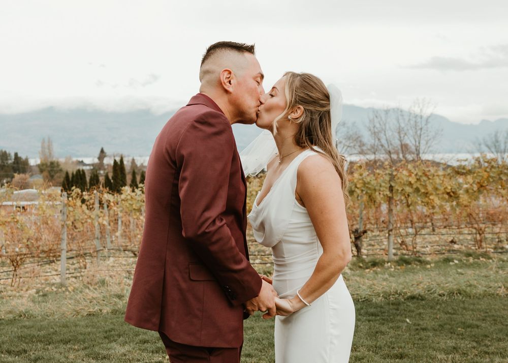 bride and groom first kiss captured by talented kelowna wedding photographer