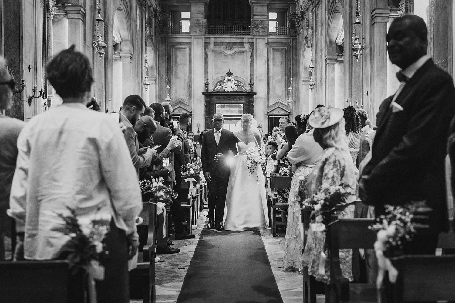 Wedding celebration in grand ornate ballroom with classic architecture.