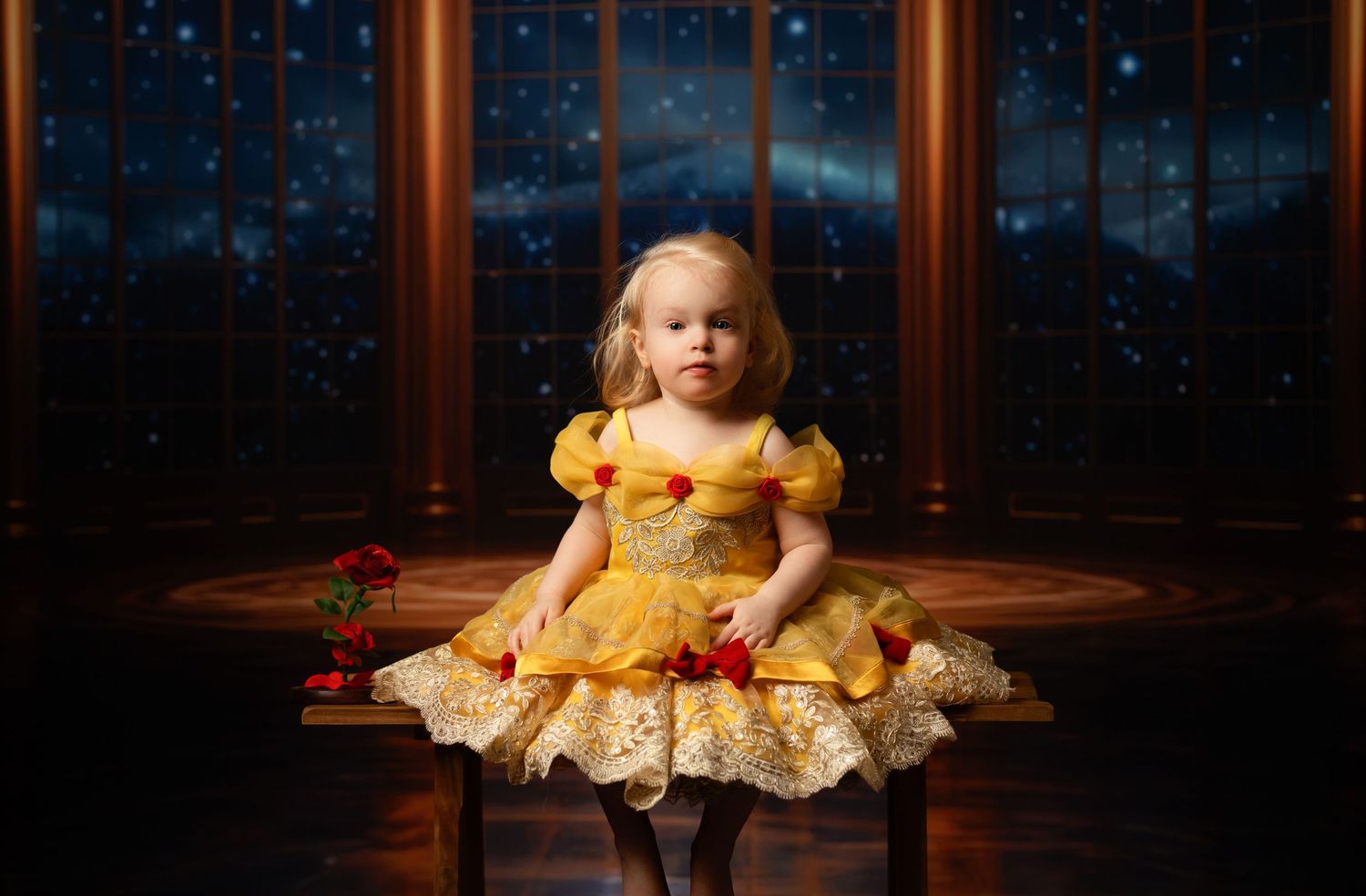 Romantic brown tulle dress captured against dark moody backdrop with dramatic lighting.