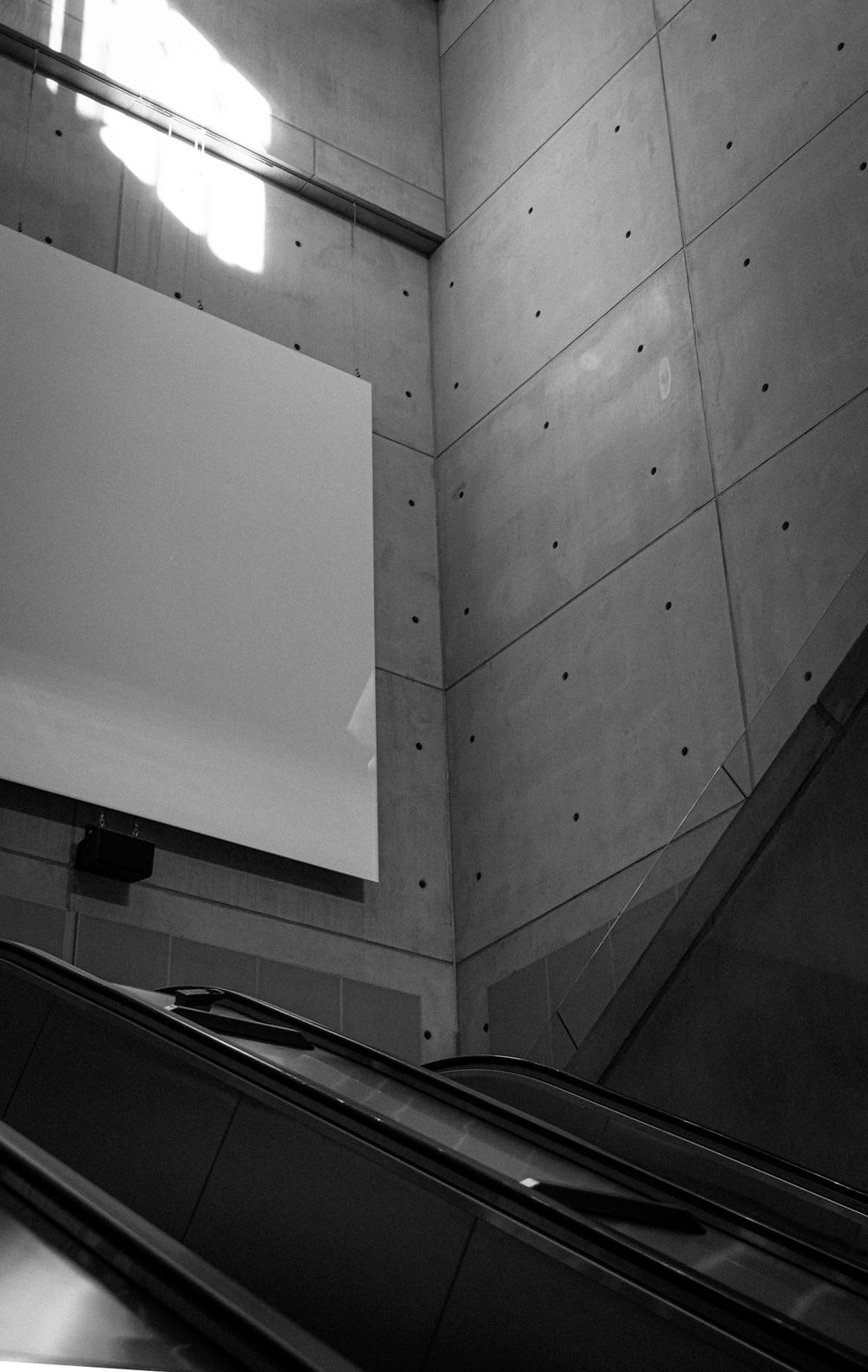 Black and white photo of a Helsinki Airport railway station concourse.