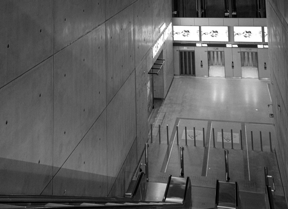 Black and white photo of a Helsinki Airport railway station concourse.