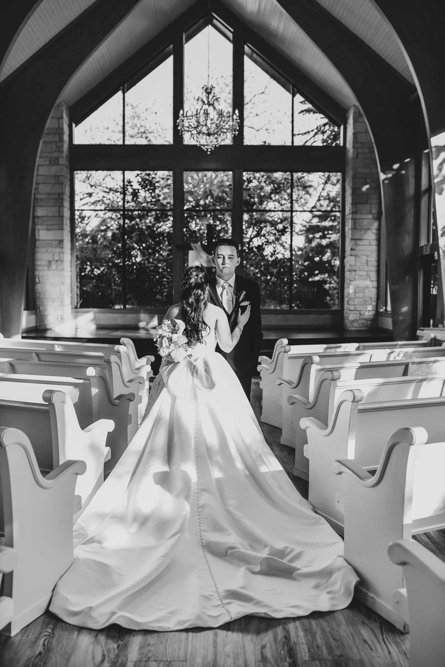 Romantic bride and groom portrait beneath crystal chandeliers