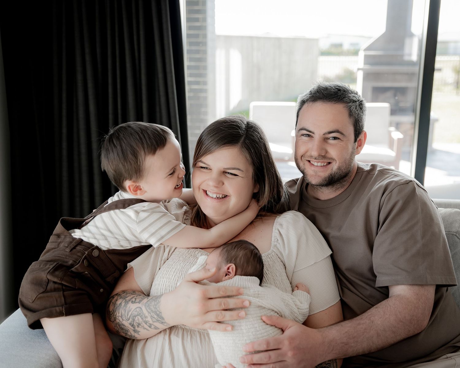 Family portrait styled in soft neutral tones during newborn session