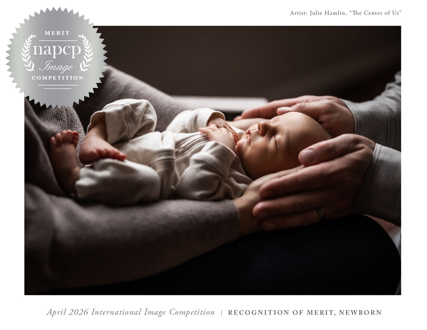 Award-winning newborn photo of a sleeping baby cradled in parents hands, Recognition of Merit NAPCP competition winner.