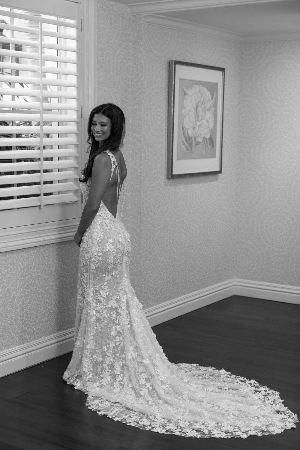 Beautiful lace wedding dress with dramatic cathedral train shown in elegant black and white photo series.