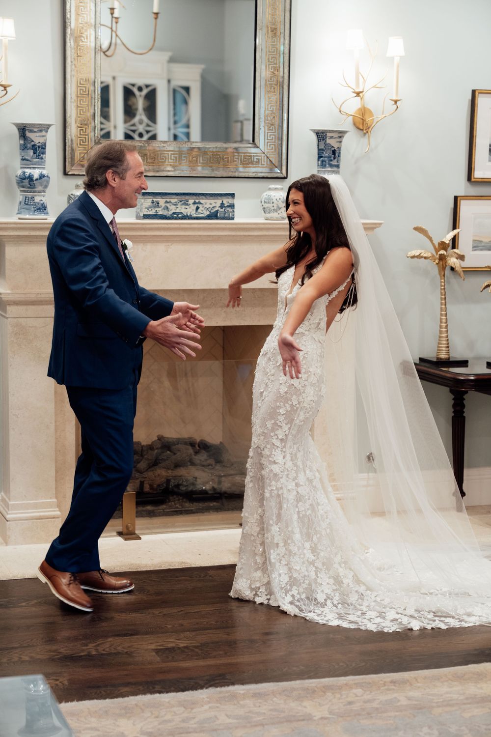 A sequence showing a couple's first look moment in an elegantly decorated room with dark wood floors and ornate walls.