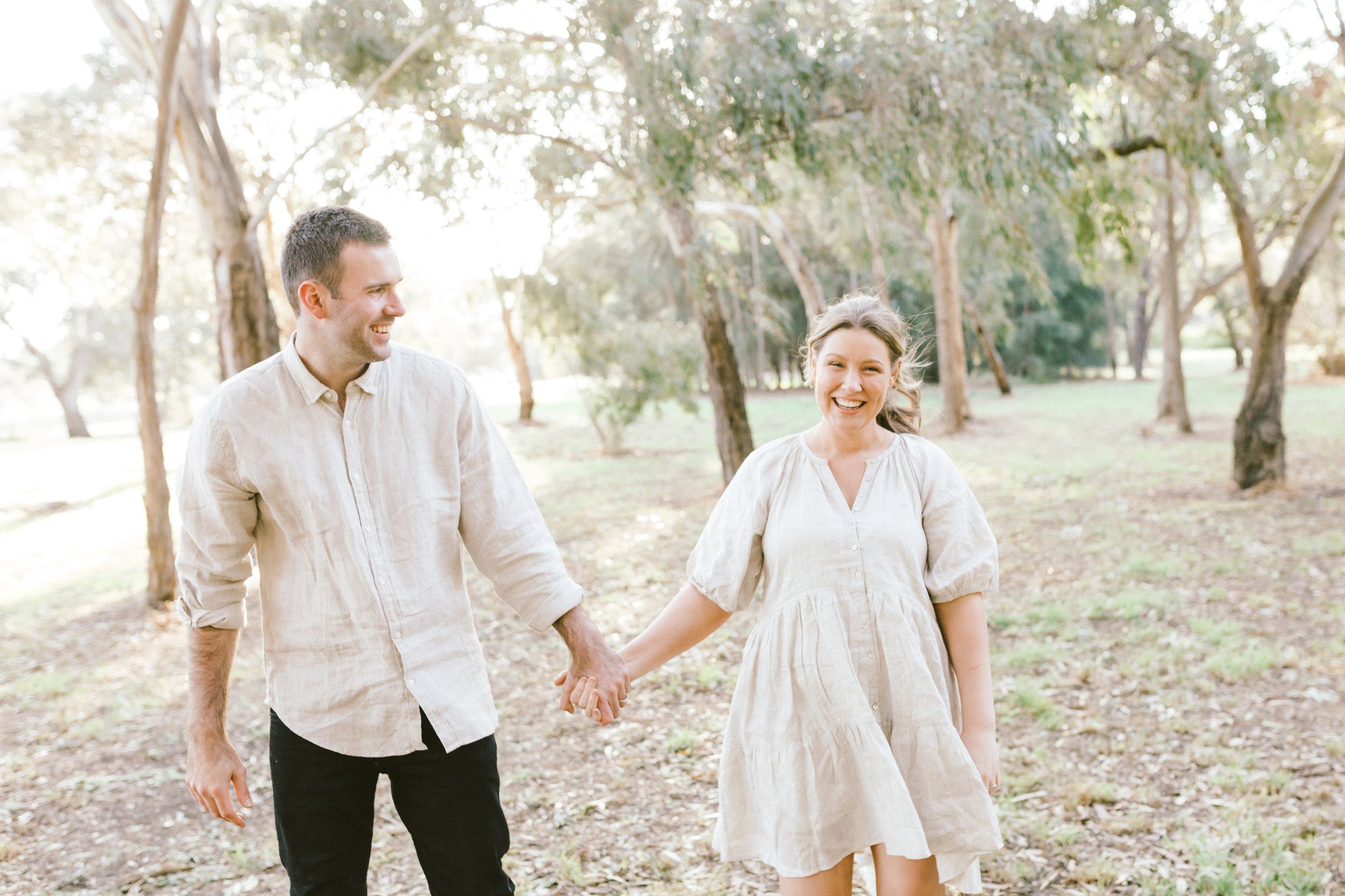 Candid family moments captured in a series of natural outdoor photos with golden sunlight filtering through trees.