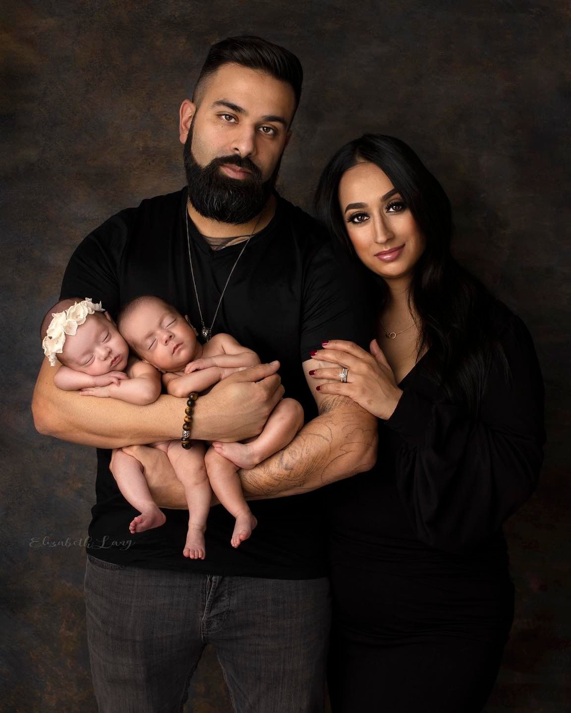 A photo series showing a newborn baby photography session with parents dressed in black against a dark background.