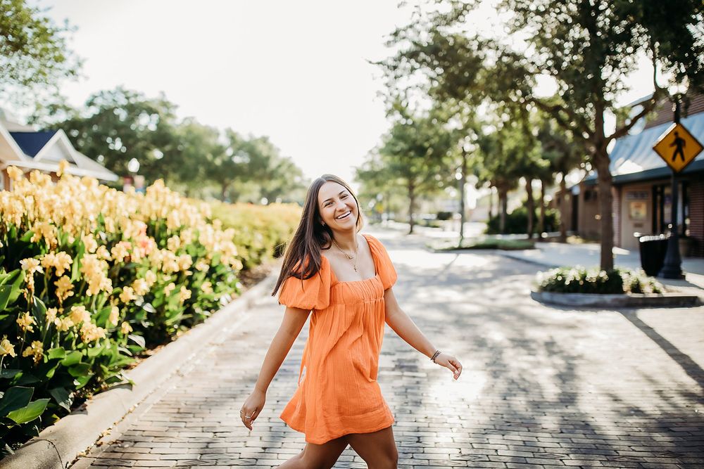 Group of six connected photos showing a person in an orange shirt walking along a sunny pathway with trees and gardens.