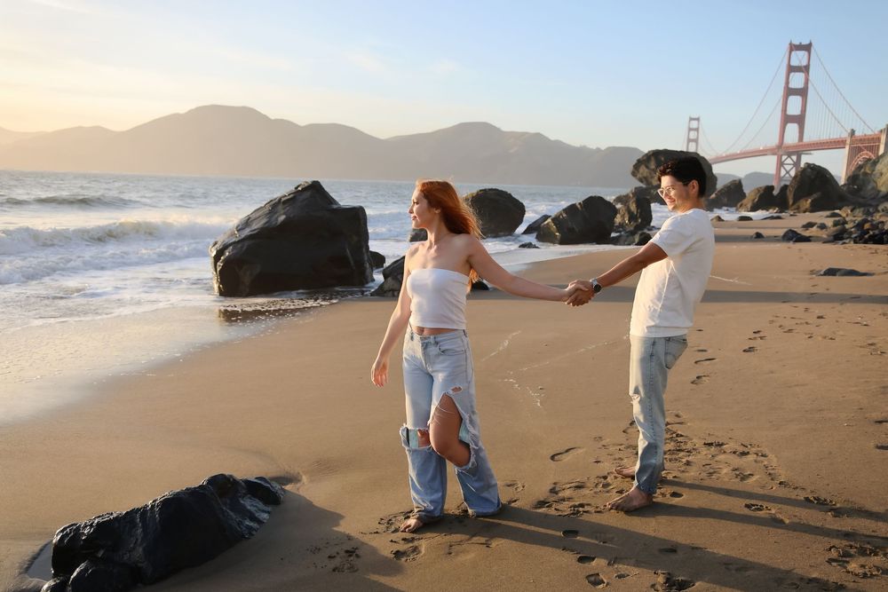 capturing couples in love  moments at Marshalls Beach in San Francisco with golden gate bridge as your backdrop