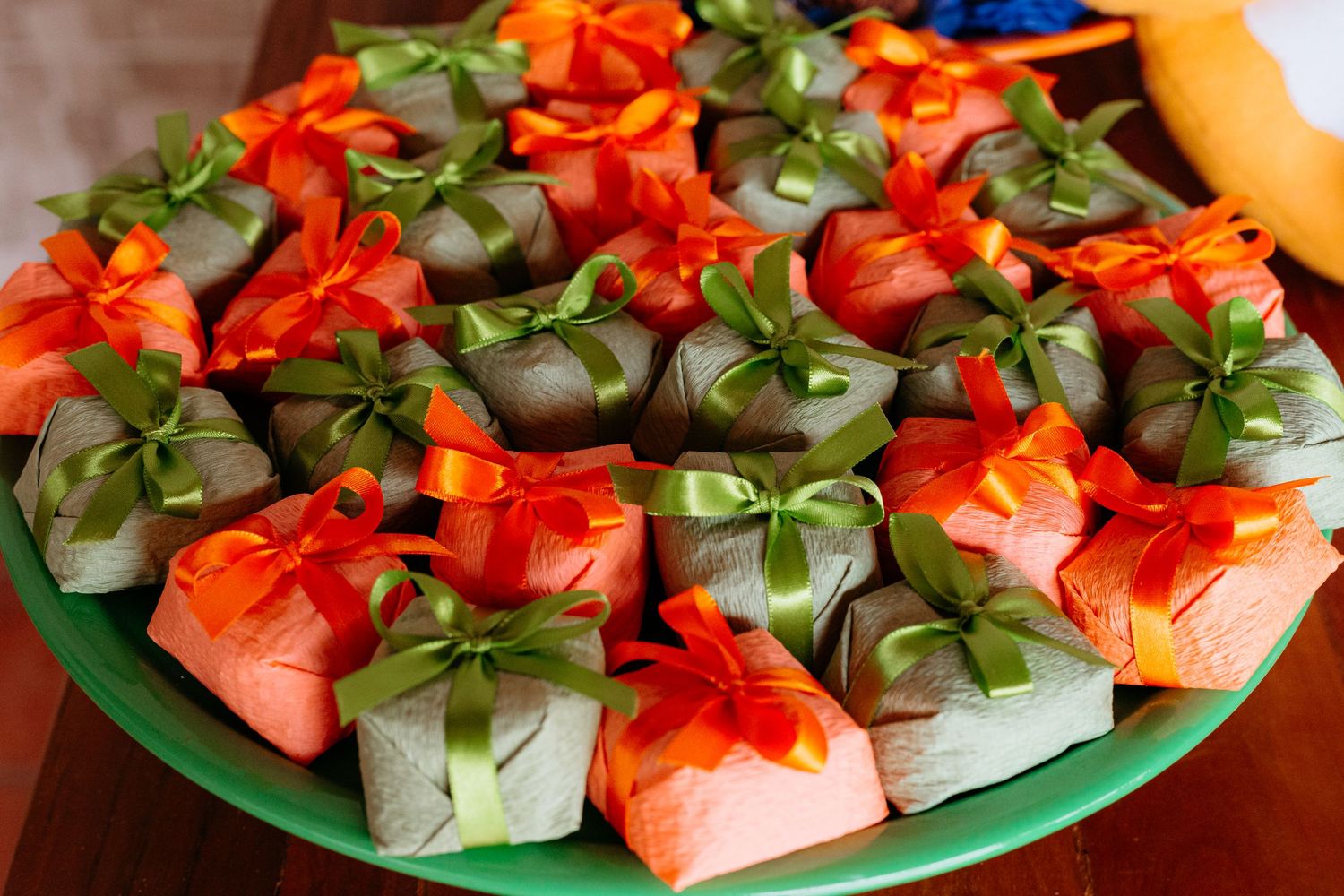 A plate of fresh watermelon cubes garnished with vibrant red flowers and green leaves served as an elegant appetizer.