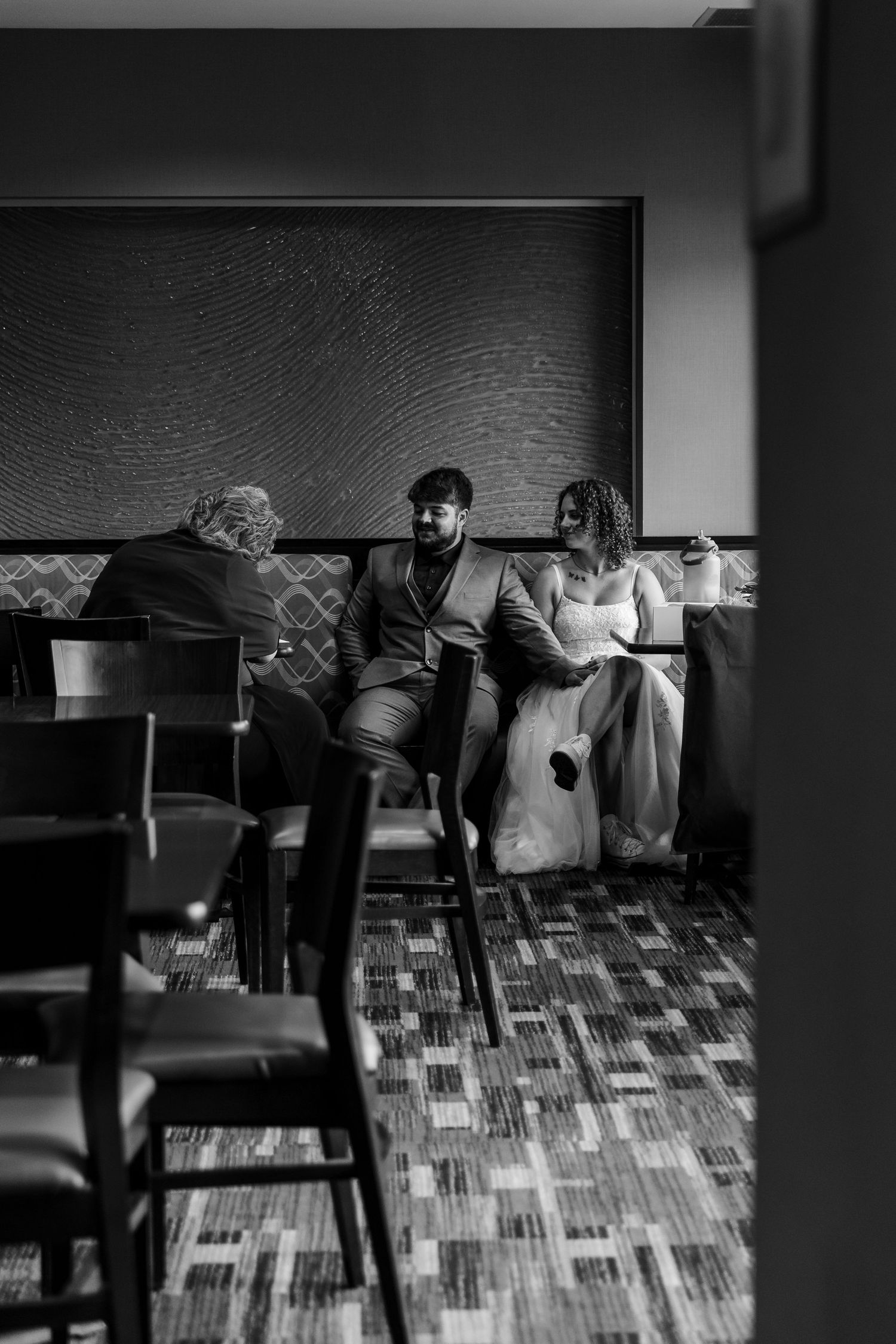 Six black and white photos showing a person browsing vinyl records at a record store in low light conditions.