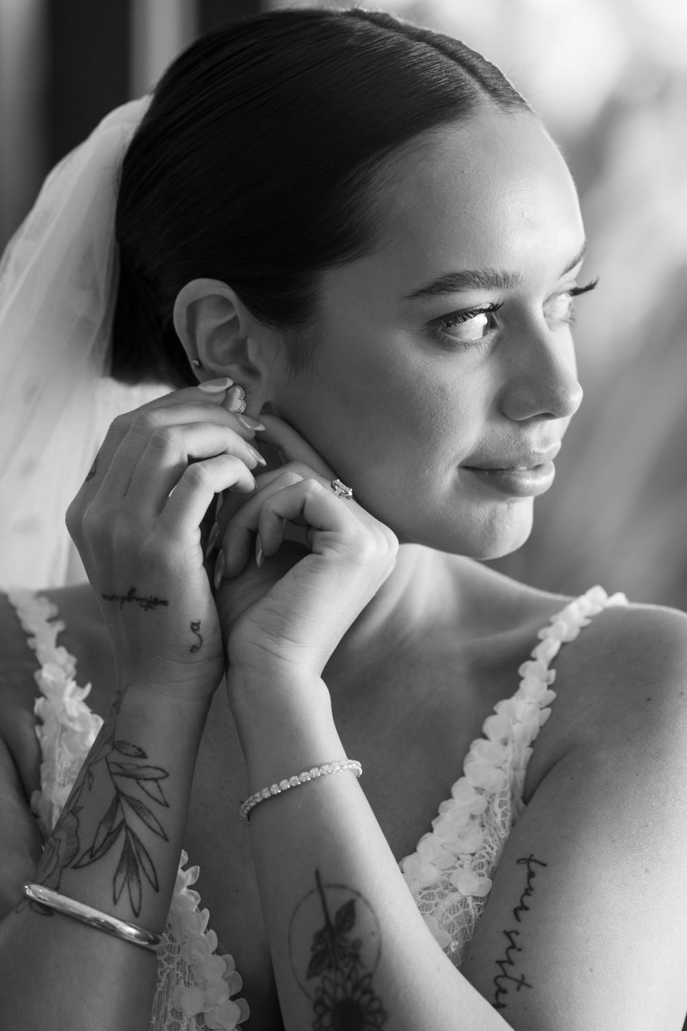 A series of black and white profile portraits showing someone in a white lace wedding dress with delicate pearl details.