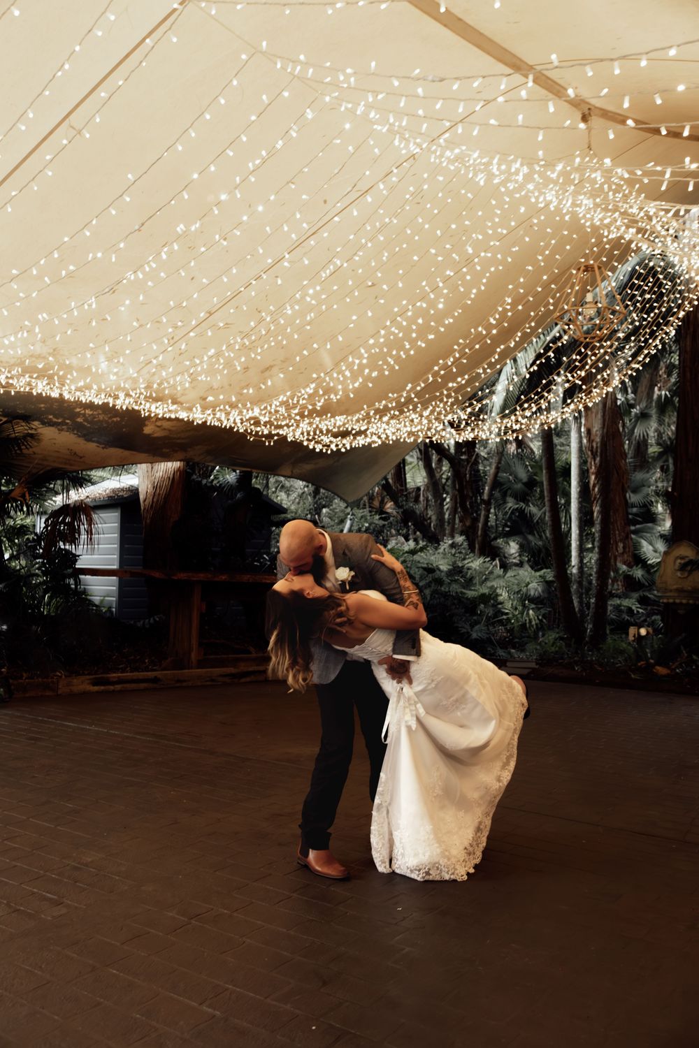 A romantic dance move sequence shown in three stages under a twinkling light canopy at a wedding reception.