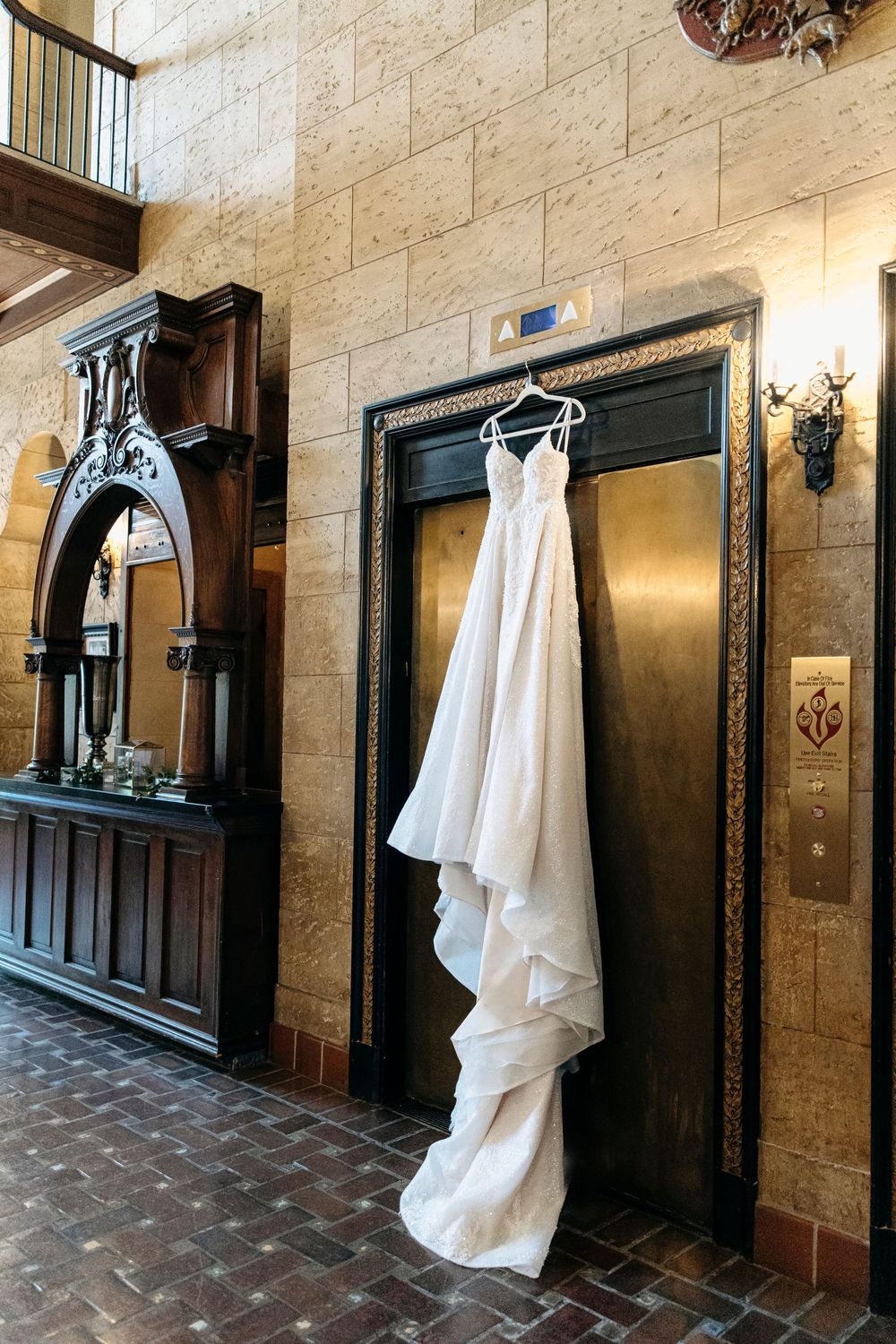 A sequence of shots showing vintage white dresses hanging on stone walls in an elegant historic hallway.