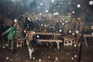 Glowing lights illuminate an outdoor evening celebration with a magical atmosphere.