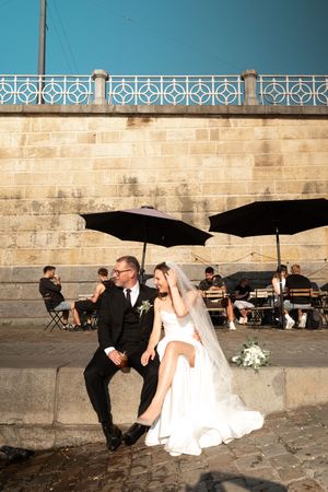 Wedding photo sequence by stone wall showing playful interaction between couple.