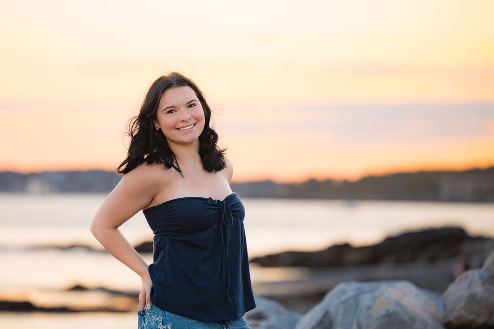 A series of sunset beach portraits showing a person in a navy blue dress posing against golden sky and ocean backdrops.