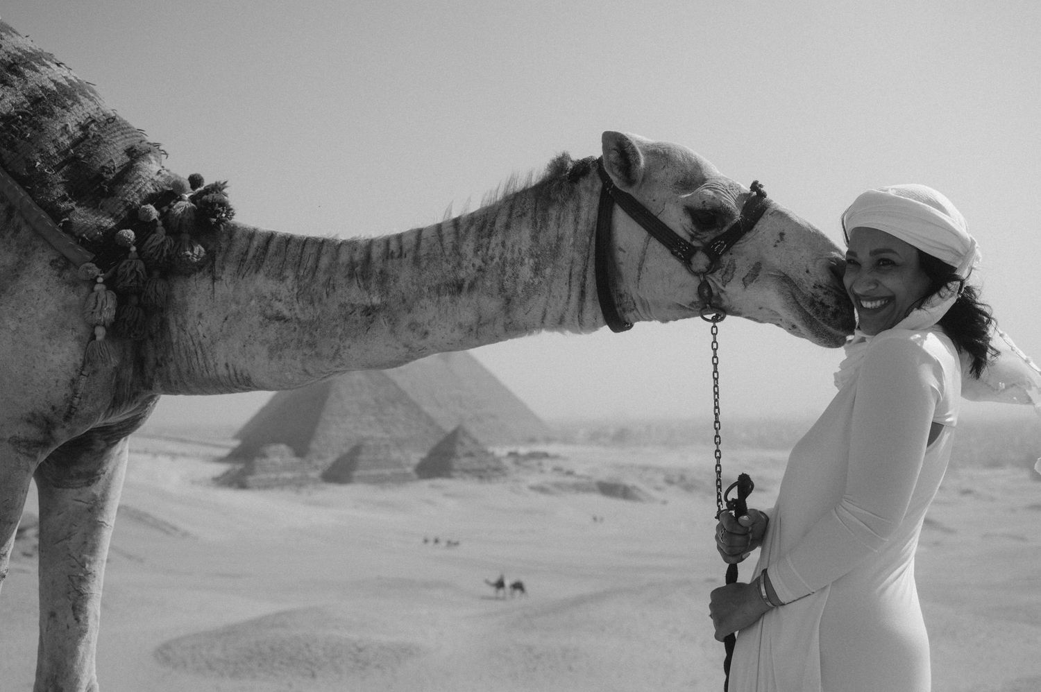 A scene of ancient pyramids and desert monuments as seen from a riding caravan in Egypt.