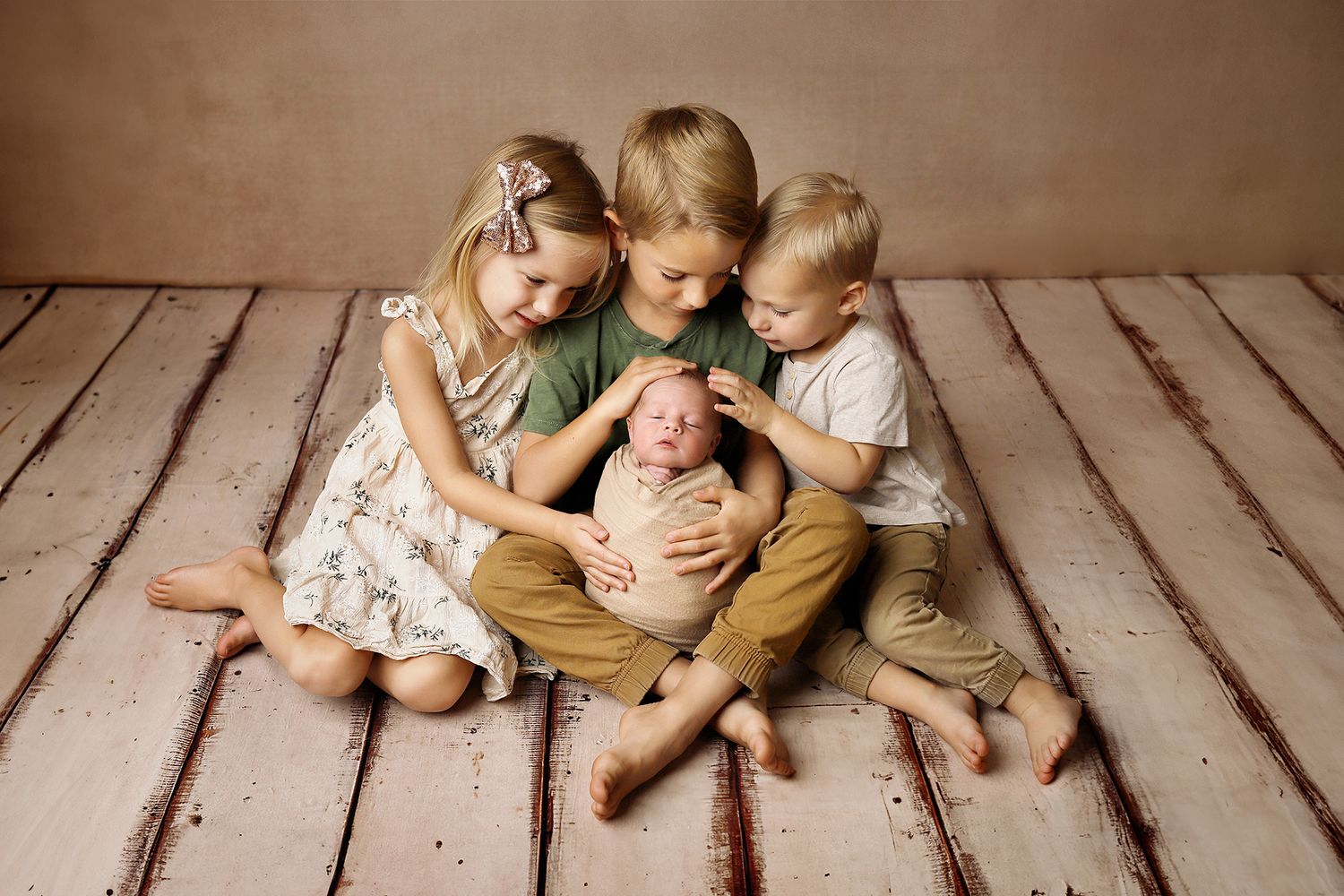 A collection of heartwarming family poses and interactions on rustic wooden floorboards during a professional photoshoot.