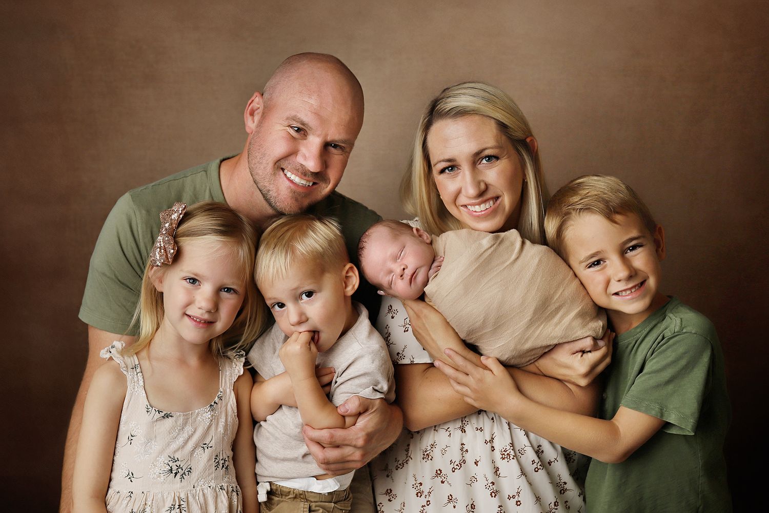 A series of six warm-toned family photographs showing intimate moments of parents and children embracing. Utah newborn and family photos