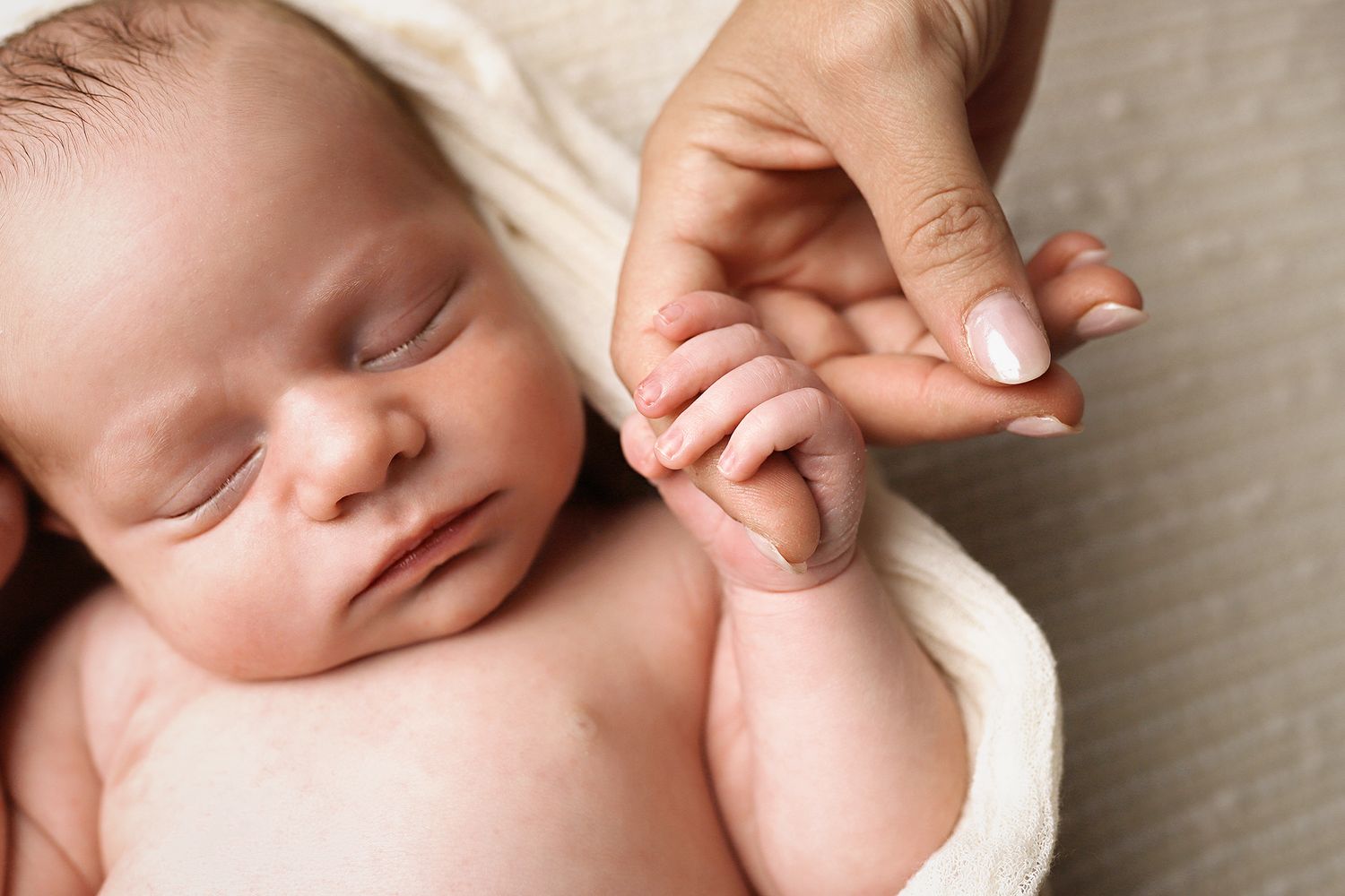 Collage of baby fingers close up showing little hands and arms gently resting against soft fabric.
