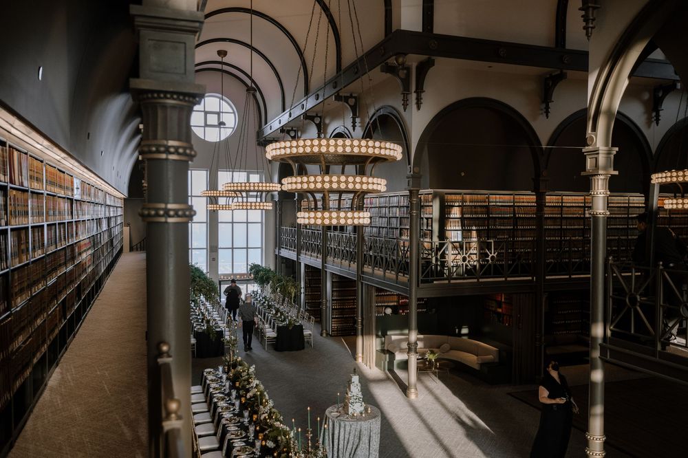 Interior of a grand historic train station with arched ceilings, elegant chandeliers and architectural details.