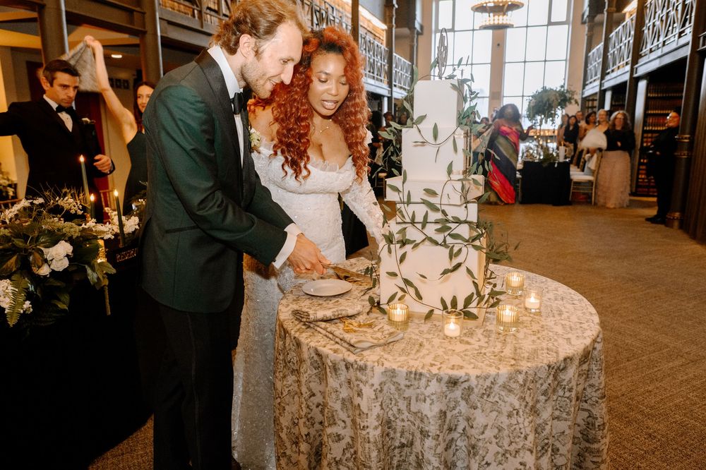 Festive celebration in a library venue with string lights and vintage decor creating a romantic ambiance.