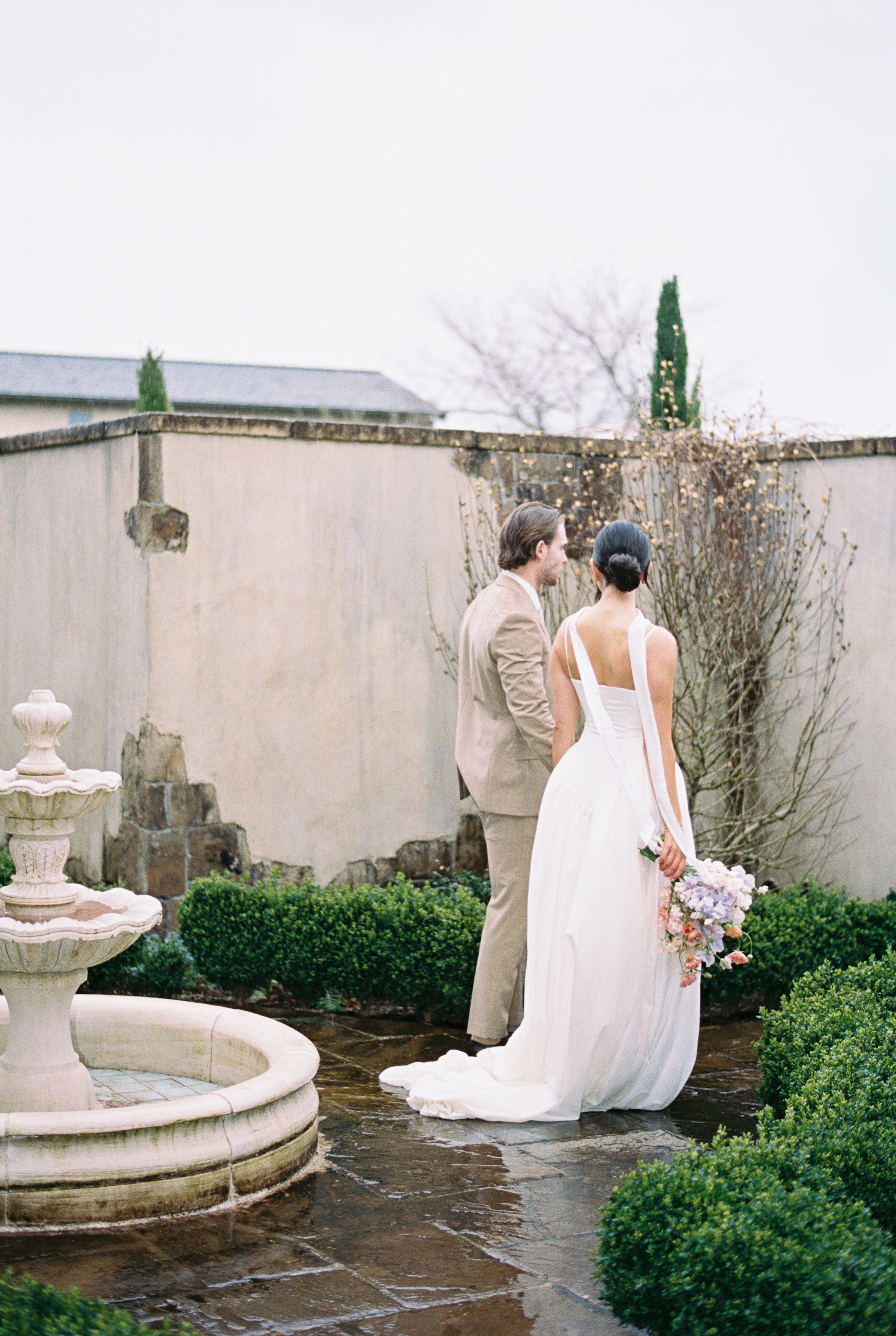 A series of four garden photos showing decorative stone fountains nestled among manicured hedges and shrubs.