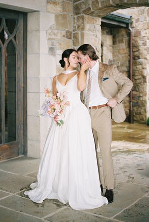 A romantic series of wedding photos showing a couple in a white dress and tan suit embracing against a stone building exterior.