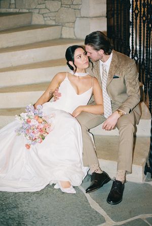 A wedding couple shares romantic poses together on stone steps in a series of black and white photos.