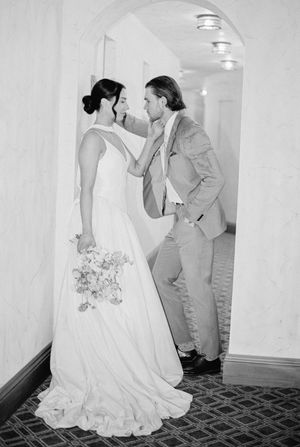 Black and white photos show playful moments between two people with one in a flowing white wedding dress.