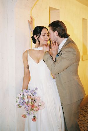 A series of romantic wedding photos showing a couple kissing in a warmly lit indoor setting.