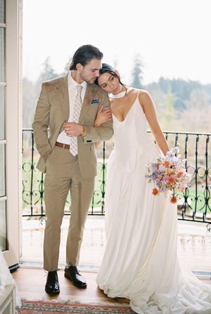A romantic wedding portrait series with the couple posing together on a elegant balcony with scenic views.