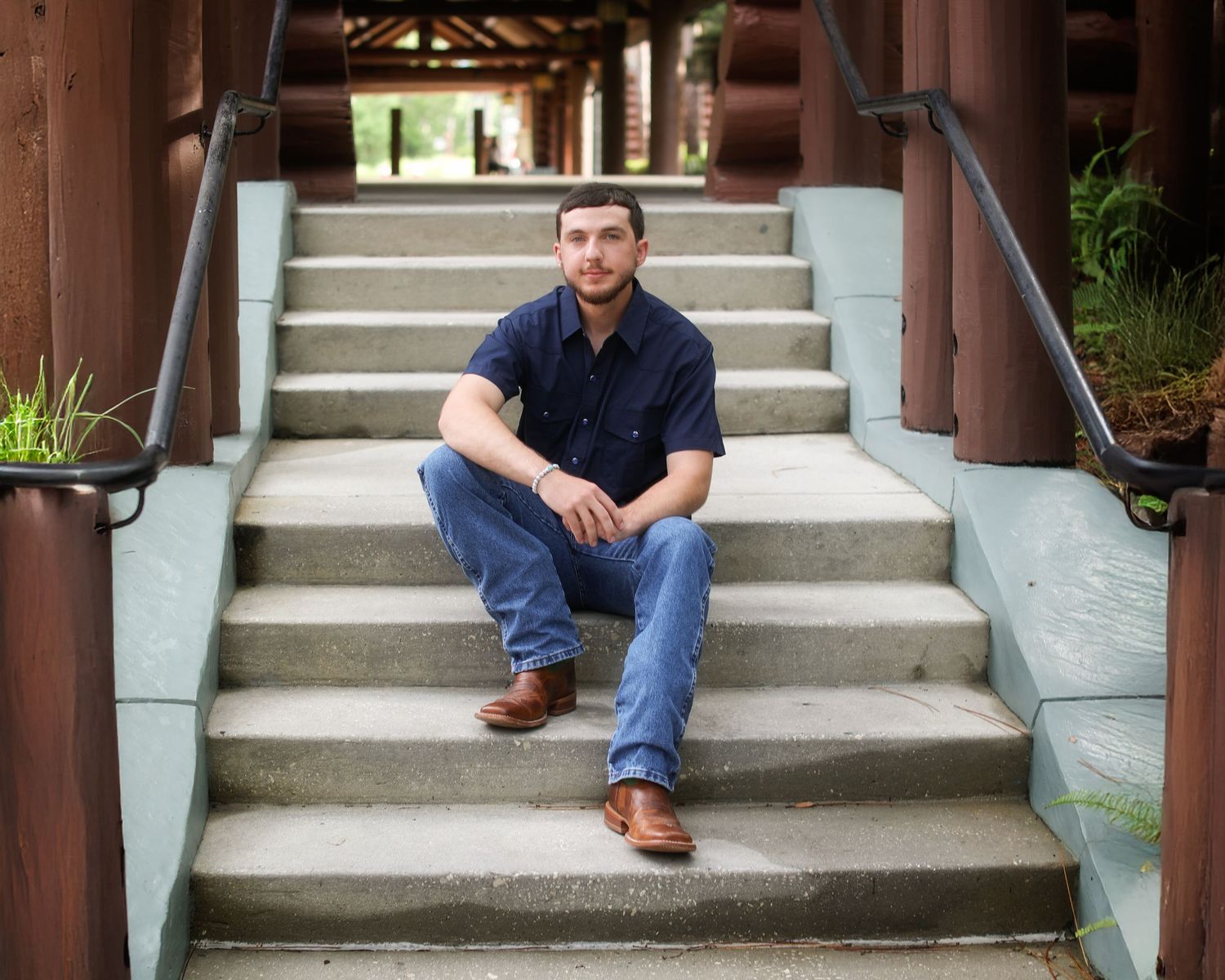 Person wearing jeans and brown shoes sitting on concrete steps in a row of repeated images.